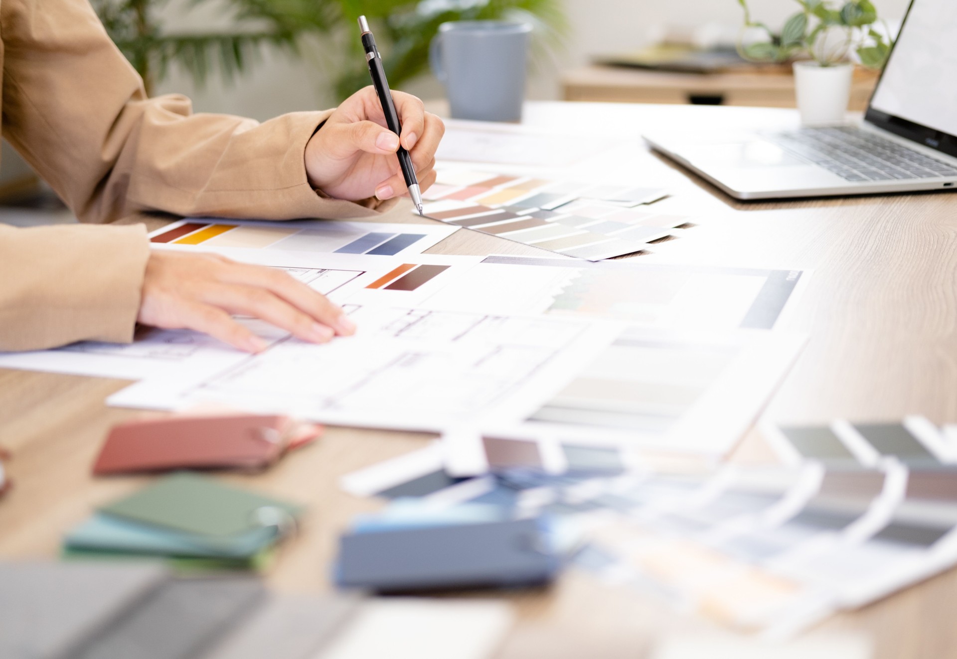 Professional interior designer working in the office, Portrait of young asian female architect working on business of Real estateproject , sketching on a house plan choosing swatches and material.
